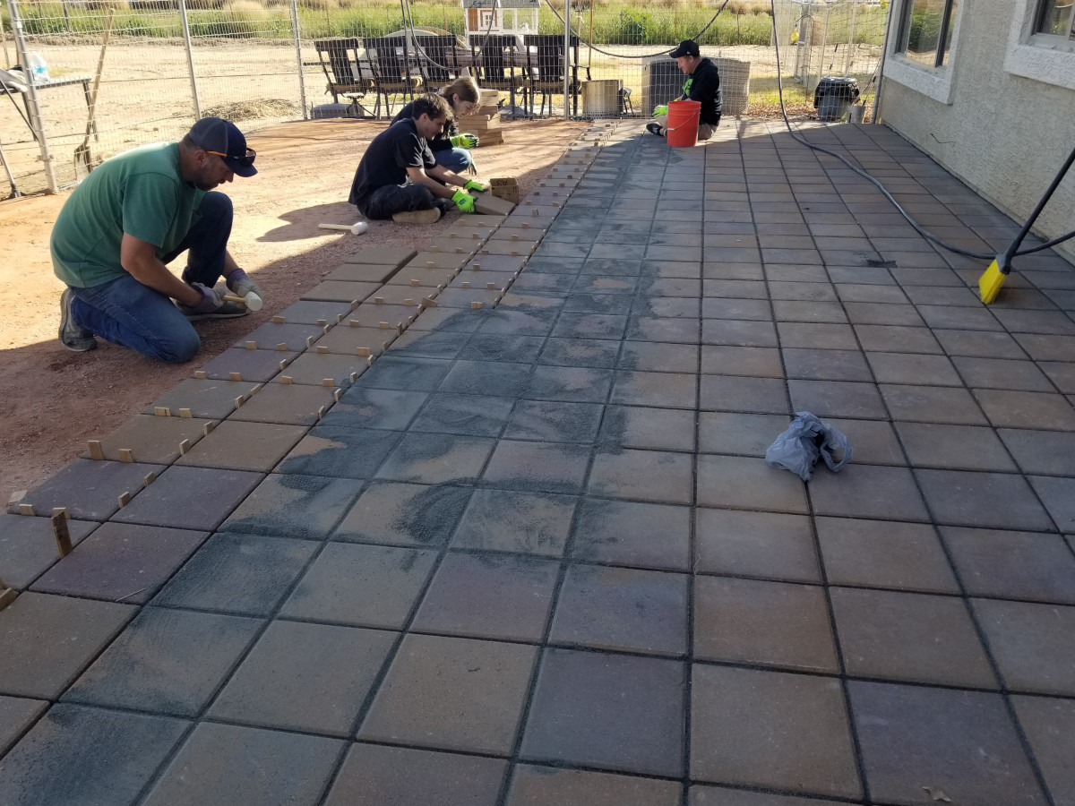 Cornerstone Concrete crew laying backyard patio pavers in Gilbert, AZ.