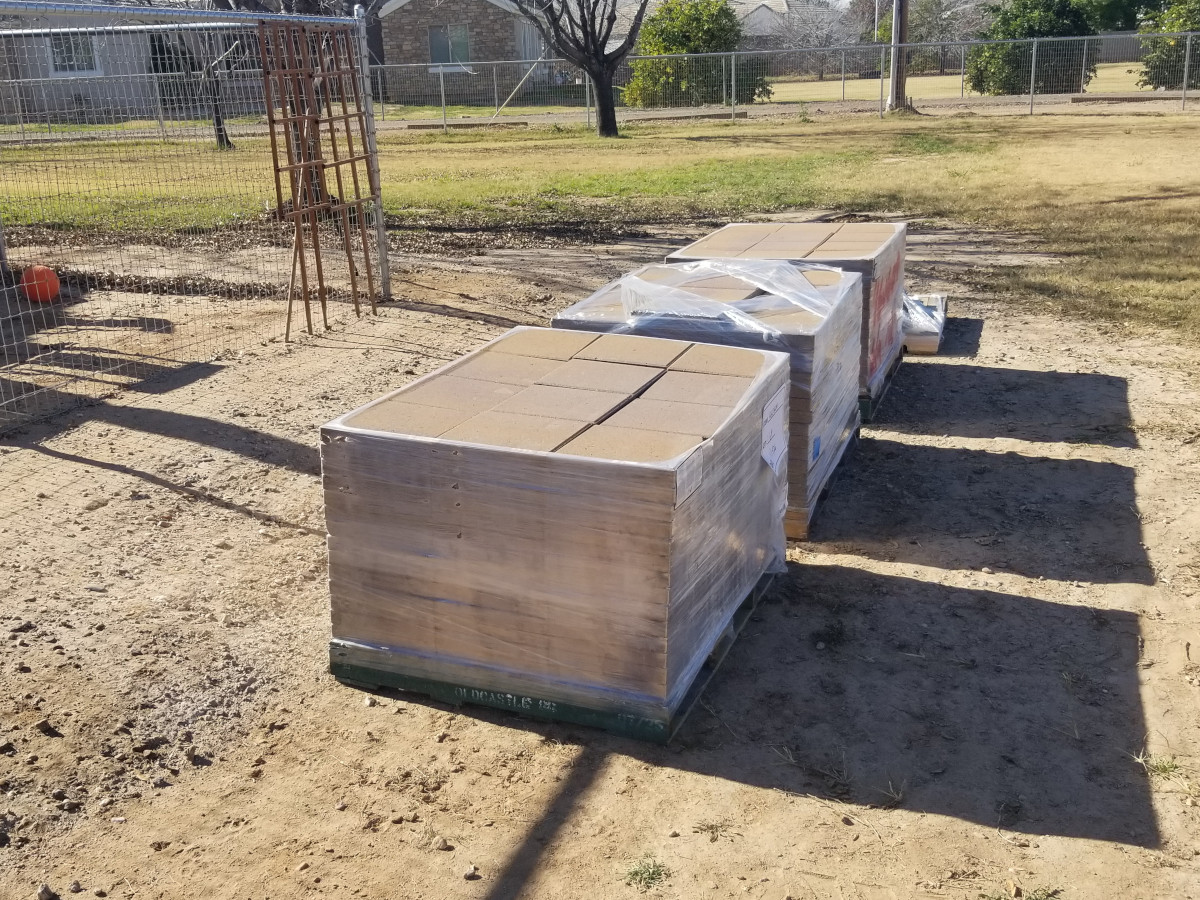 Pallets of pavers delivered to a residential backyard project in Gilbert, Arizona.