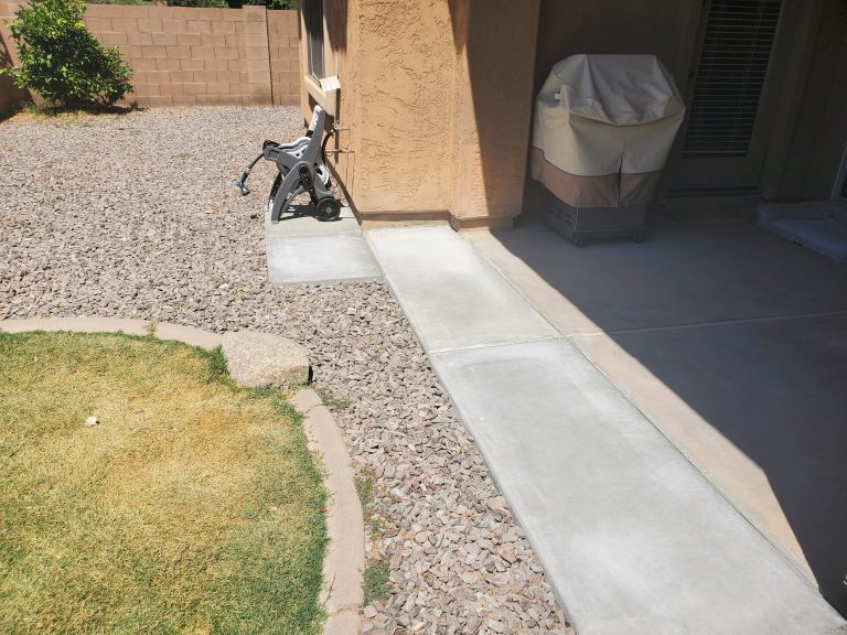 A completed concrete job extending a backyard patio for a residential home in Chandler, Arizona.