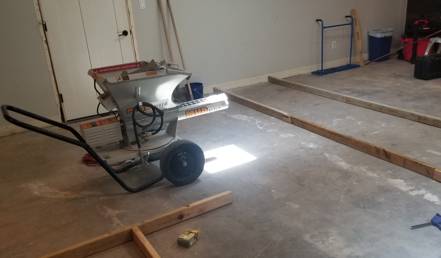 Mud mixer machine sitting indoors ready for a concrete pour project.