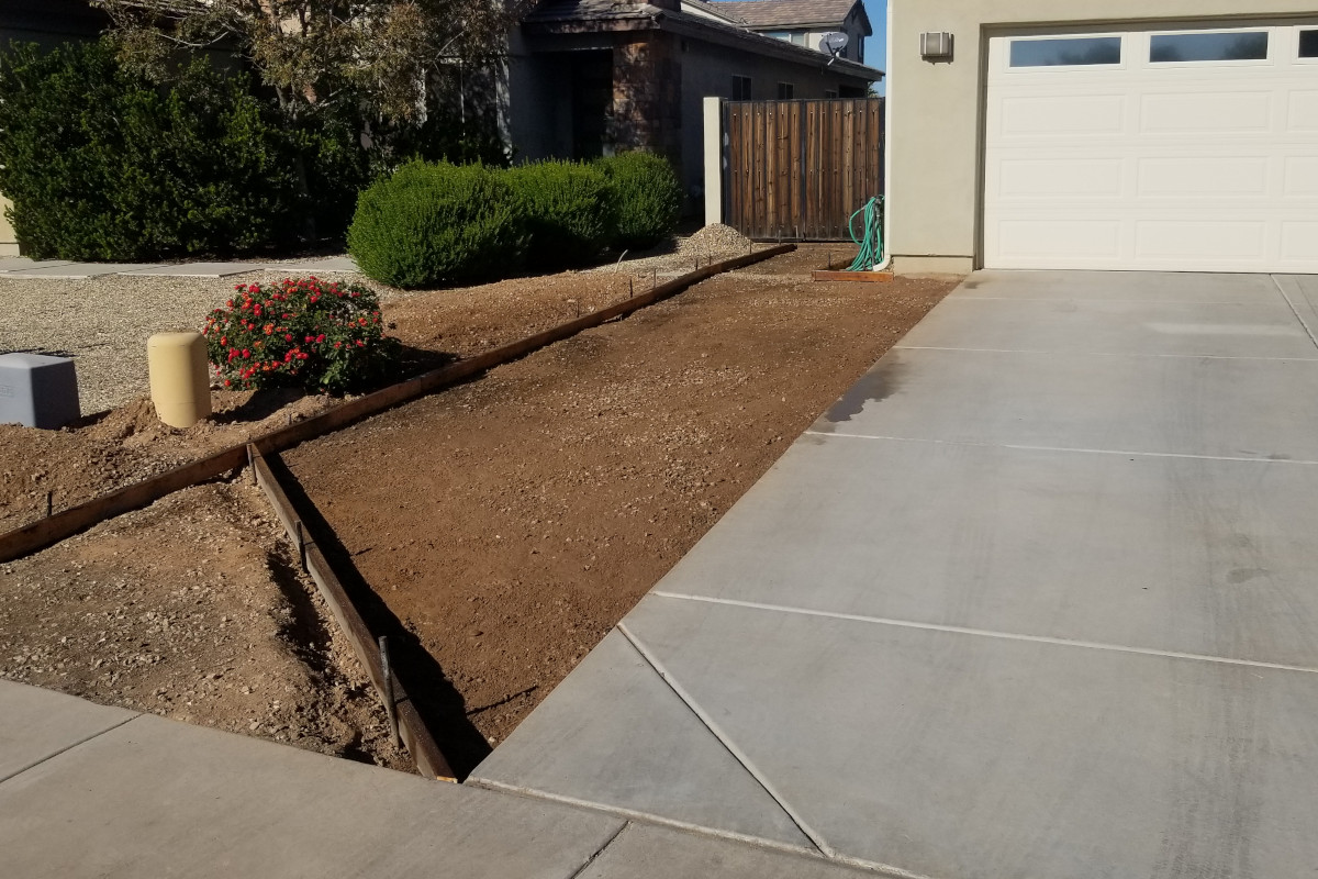 Concrete driveway setup with forms, ready to be poured on neatly graded ground