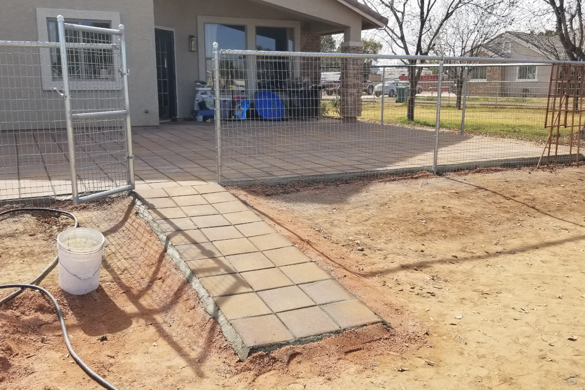A view showing the walkway of pavers leading up to the back patio area