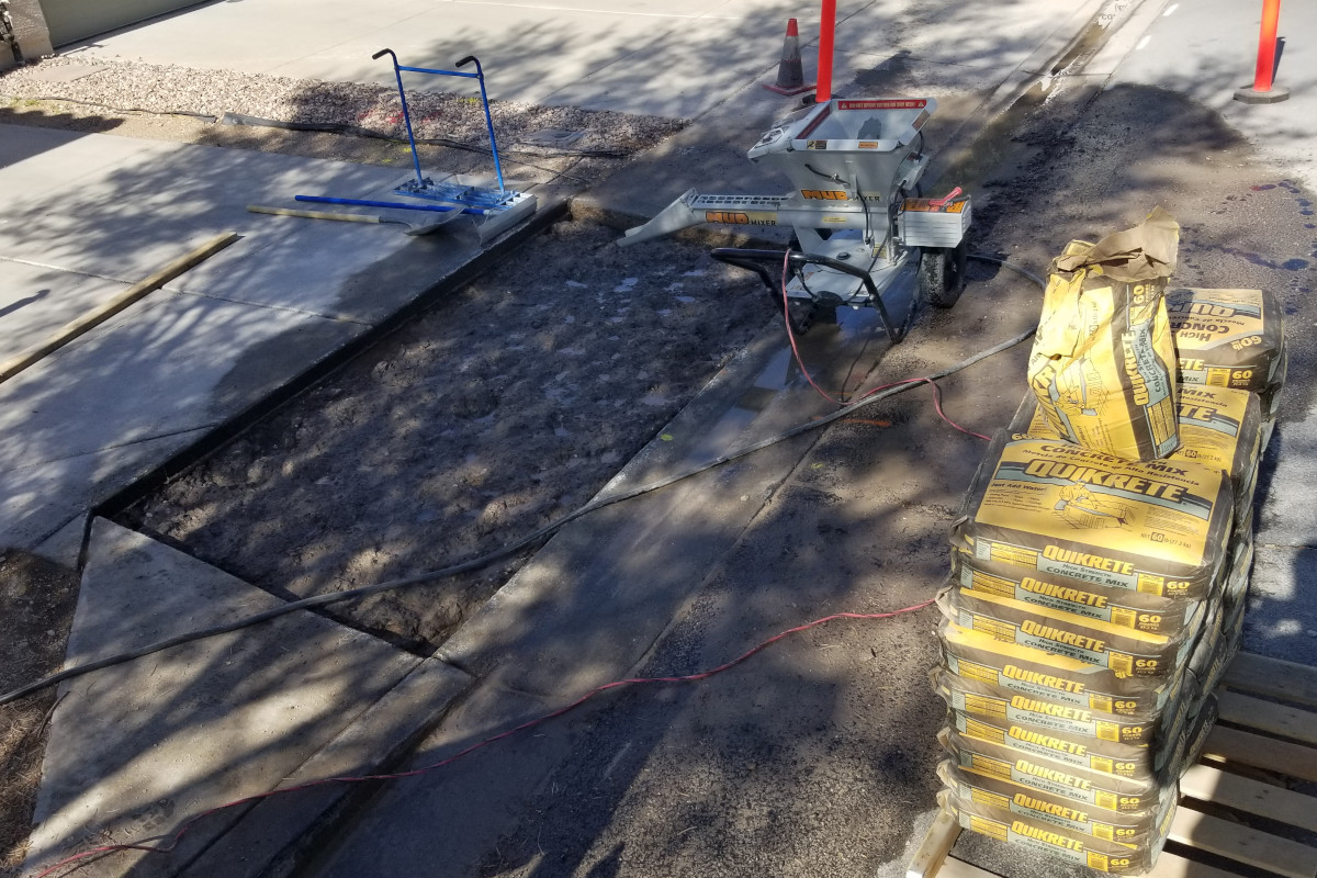 Concrete bags and mini mixer ready to pour