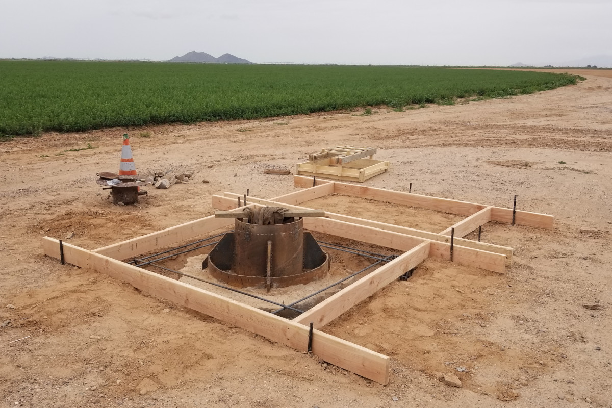 Concrete forms and rebar setup around a well head