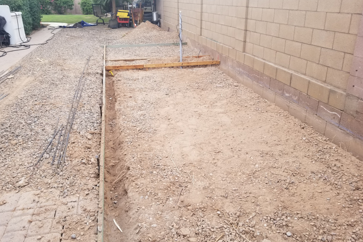 Forms and base prep for a Chandler concrete shed pad and side-yard patio section.