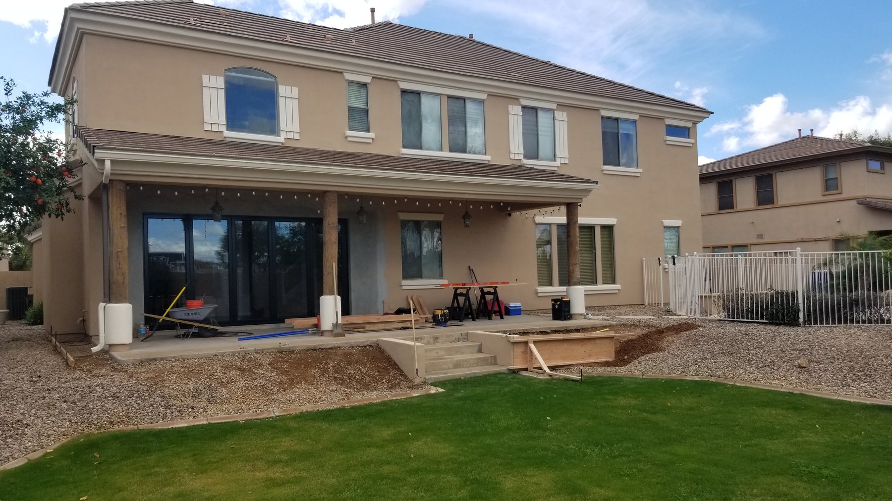 Backyard patio, steps, gravel and lawn before the Chandler extension