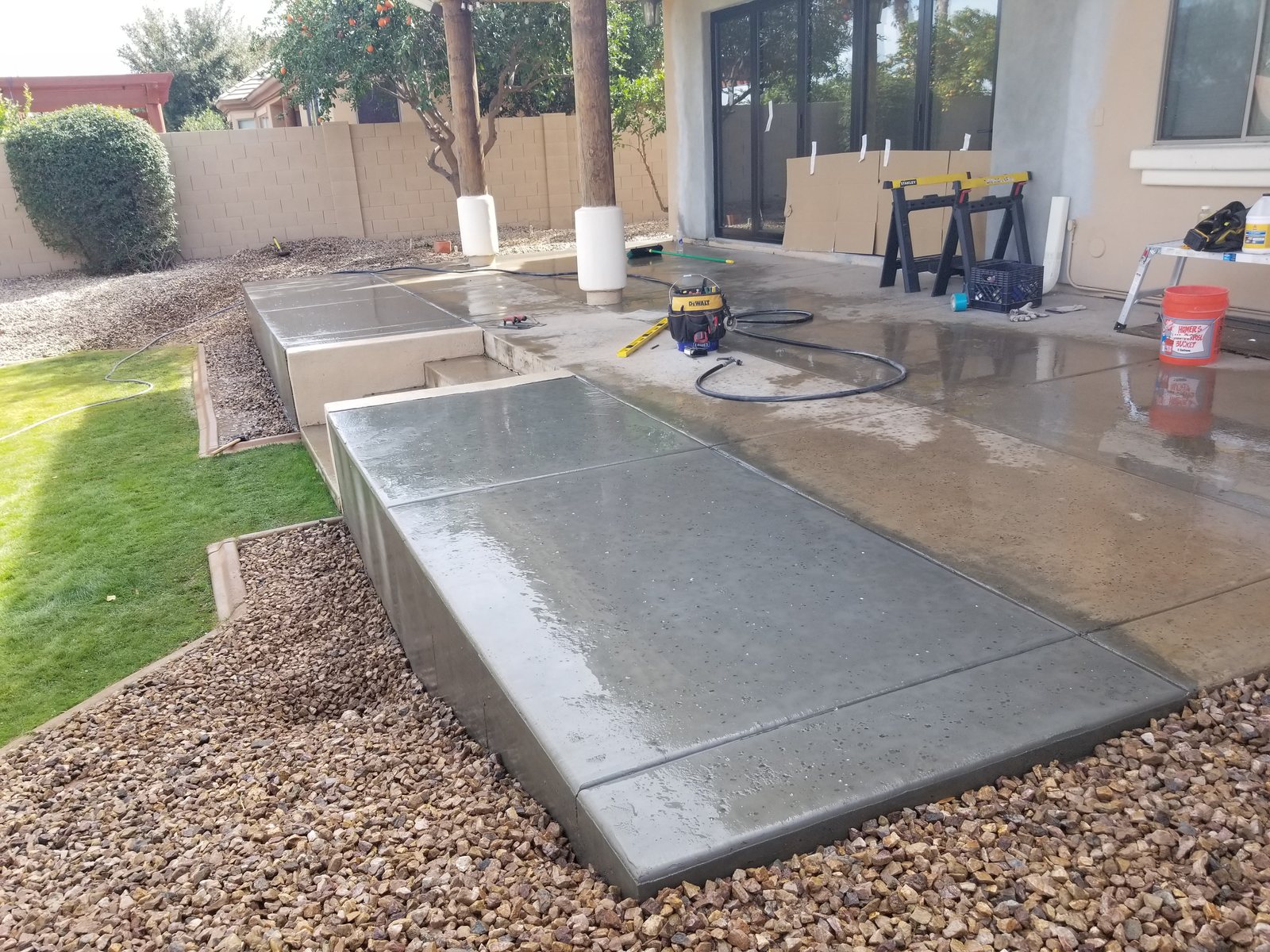 Close view of the new patio surface, steps and raised concrete edge