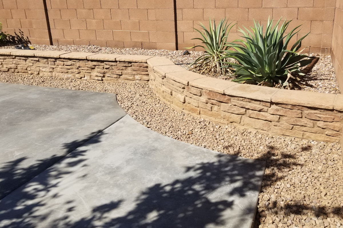 Curved patio edge tying the new concrete into the surrounding backyard layout.