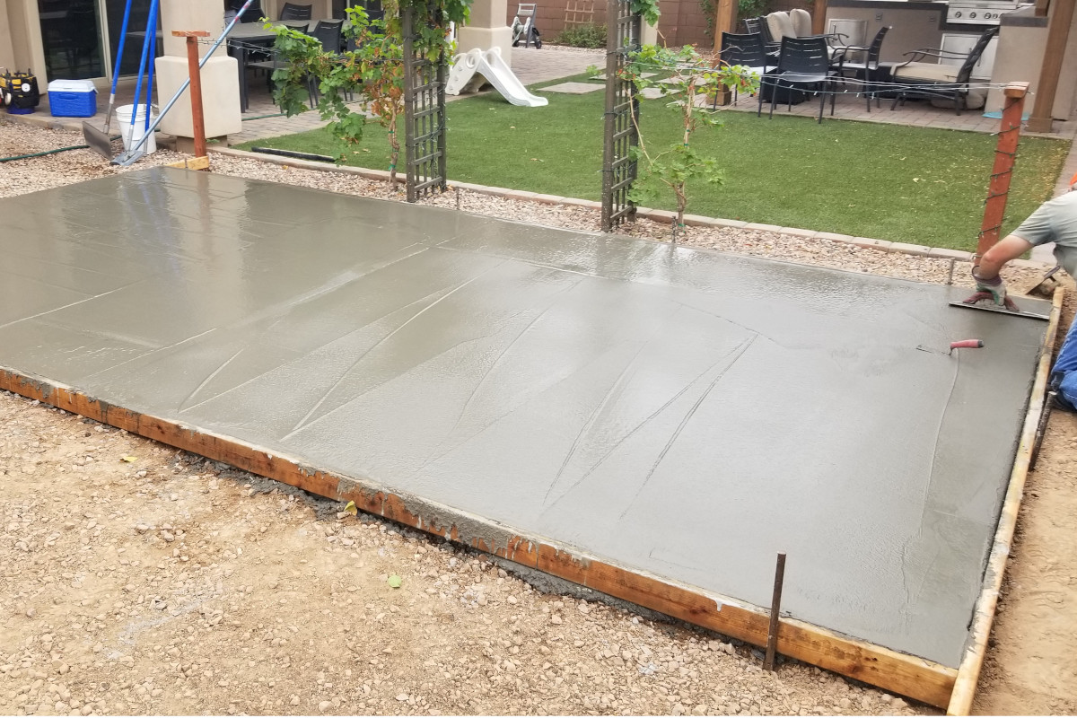 First pour section of a backyard concrete patio during finish work.