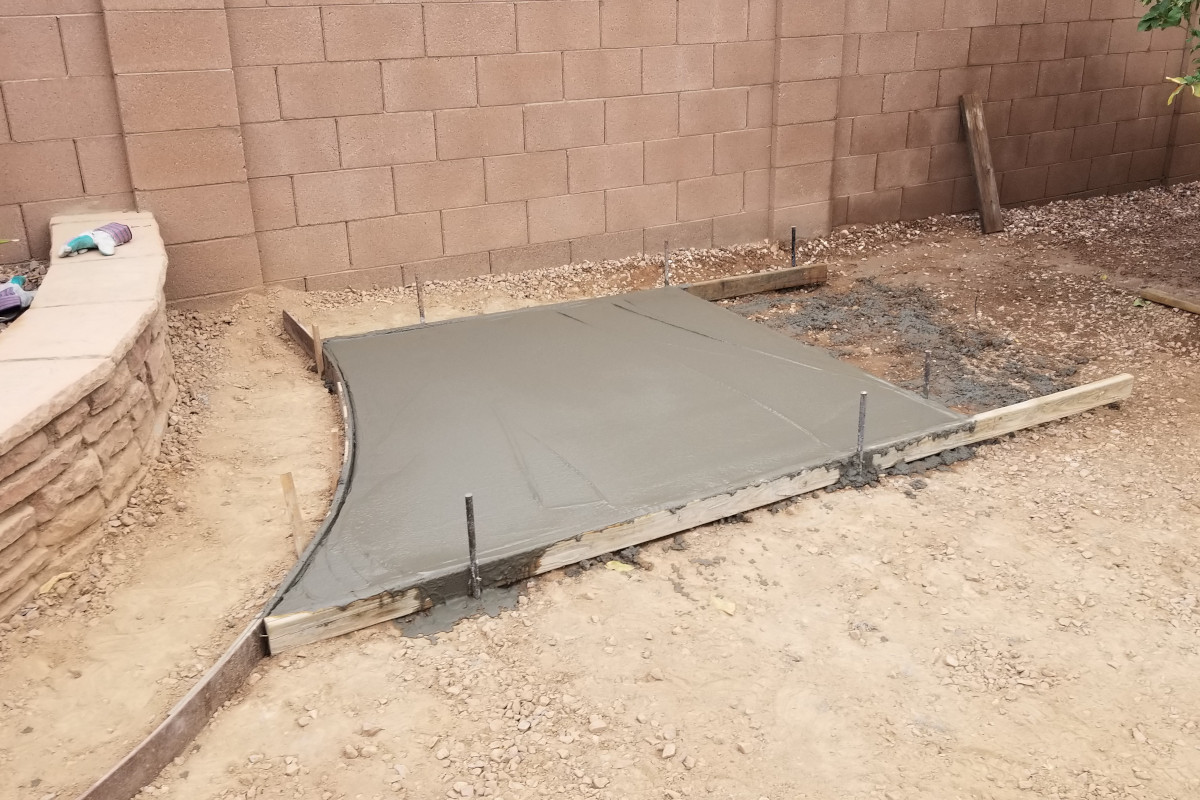 Fresh concrete section wrapped around the backyard tree planter.