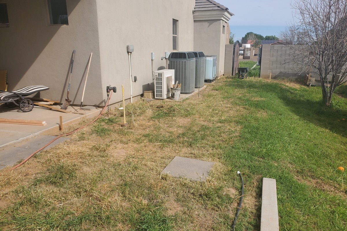 Before view of the Gilbert side yard before the concrete sidewalk addition was built.