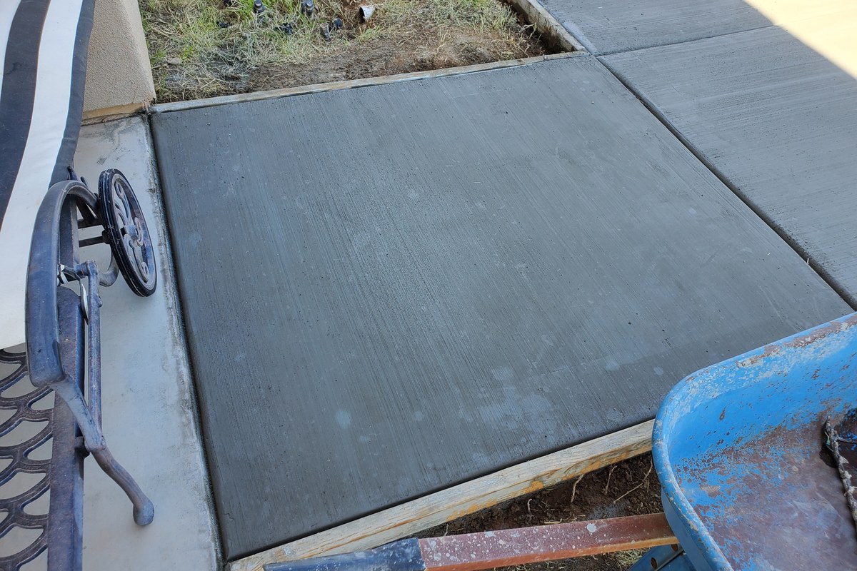 Close-up of the finished broom texture and clean panel layout on the new sidewalk addition.