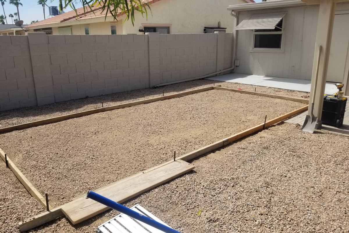 Formed backyard concrete slab area prepared for a future shed.