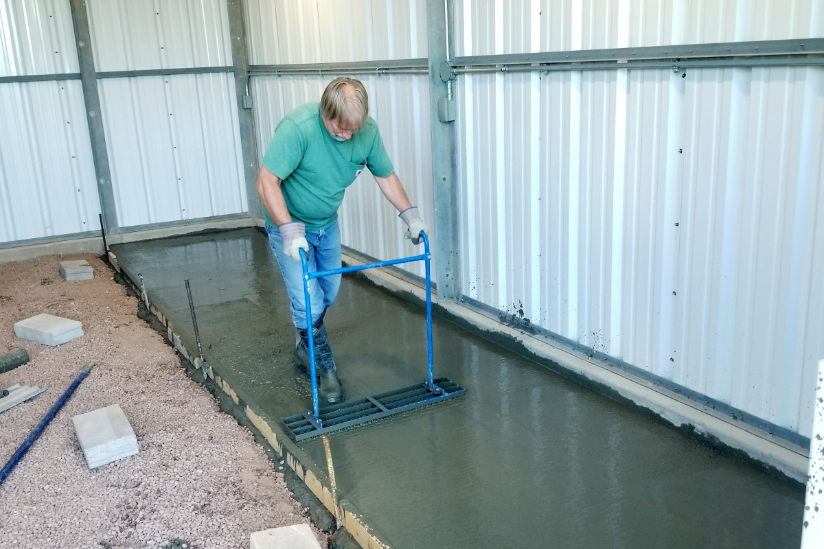 Finish work in progress on a concrete tool-storage slab inside a Chandler shop.