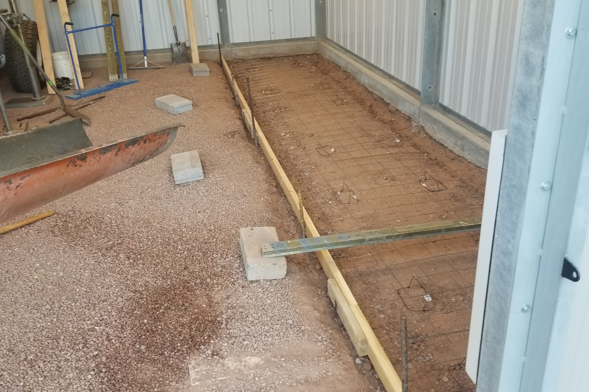 Formed tool-storage slab area in Chandler with metal reinforcement installed before the concrete pour.