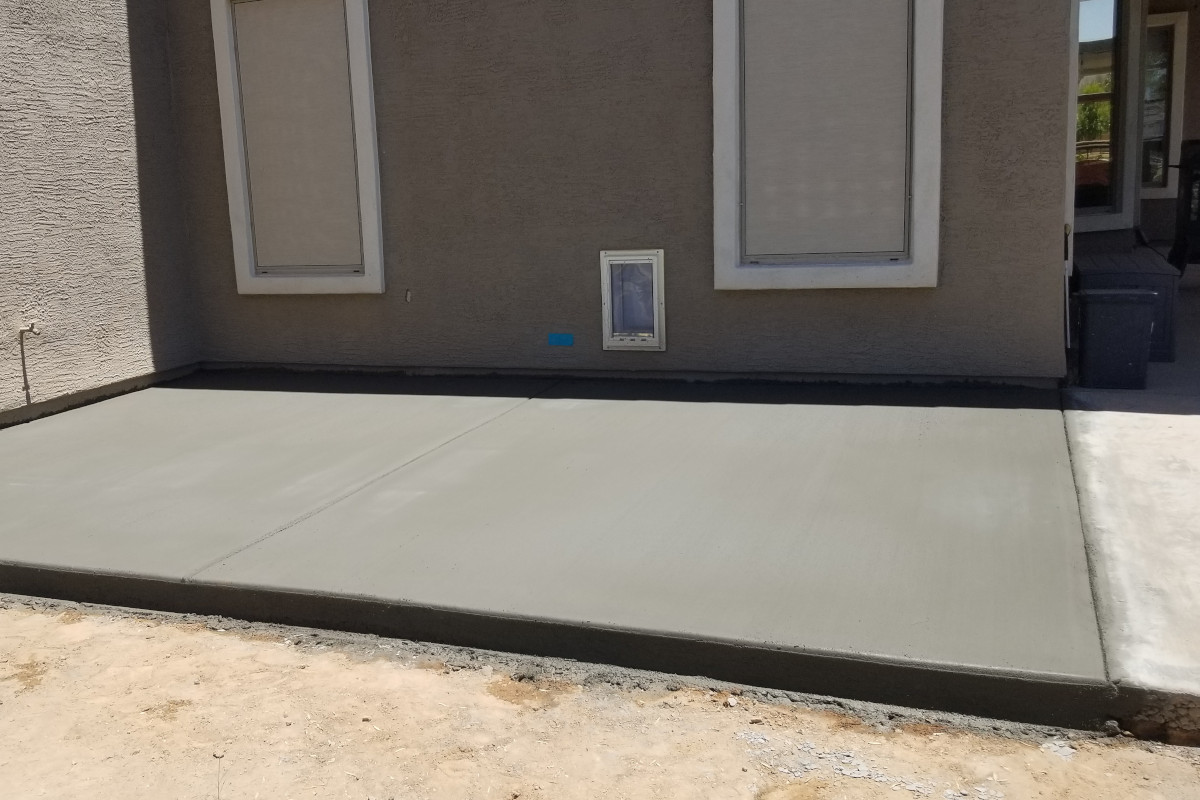 Finished front view of the extended concrete patio and dog pad in Gilbert.