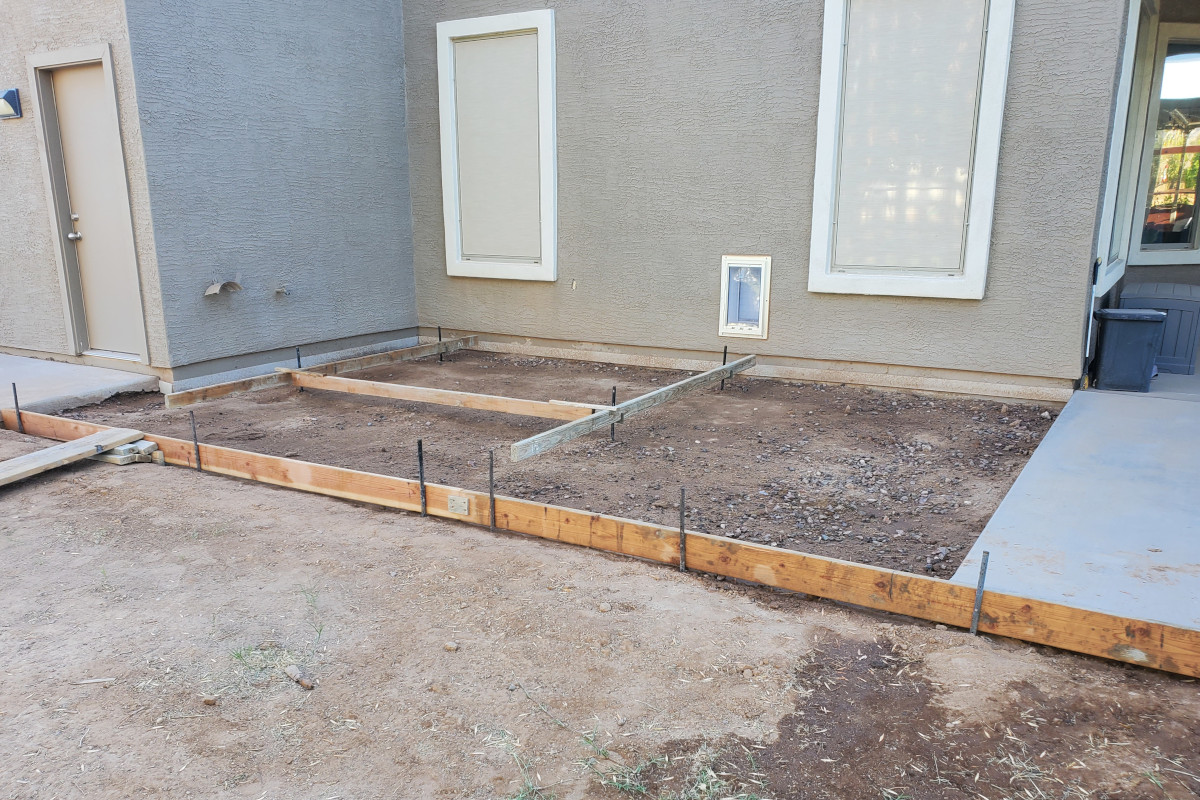 Patio extension forms set in place for a new concrete dog pad and backyard slab addition in Gilbert.