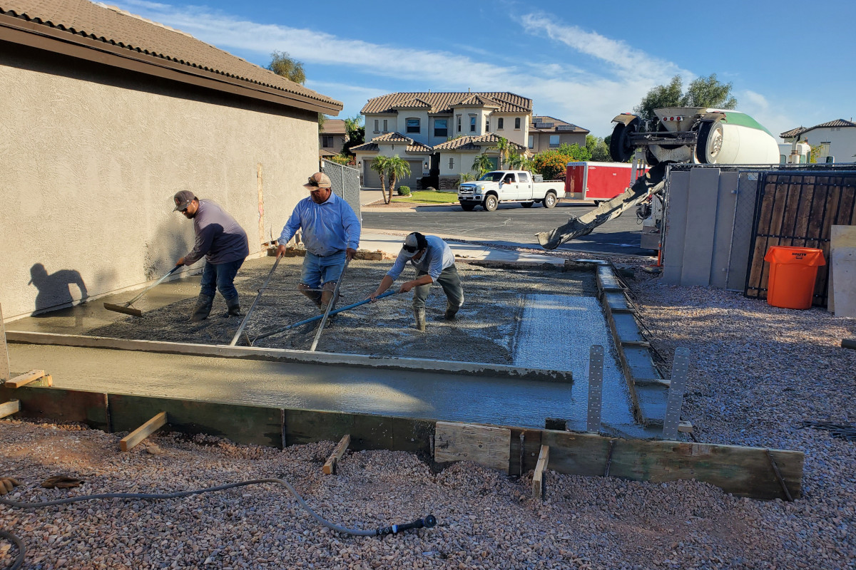 Concrete crew placing the garage addition slab in Gilbert, Arizona.