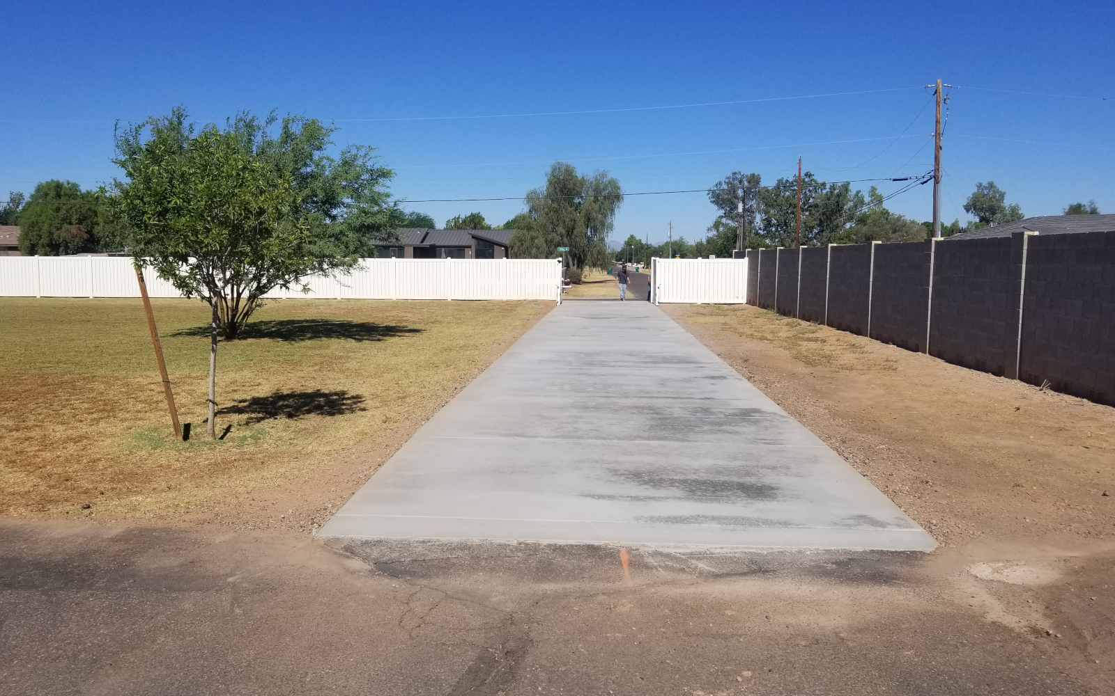 Finished 100-foot concrete driveway extending through a Gilbert property