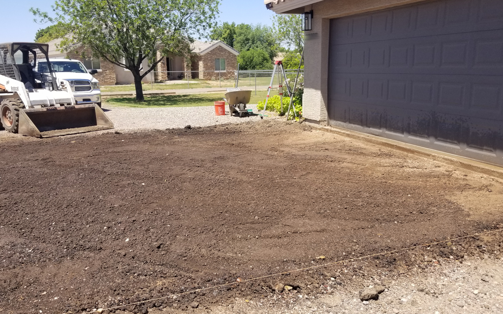 Prepared base beside a Gilbert garage for a driveway section and basketball hoop pad.