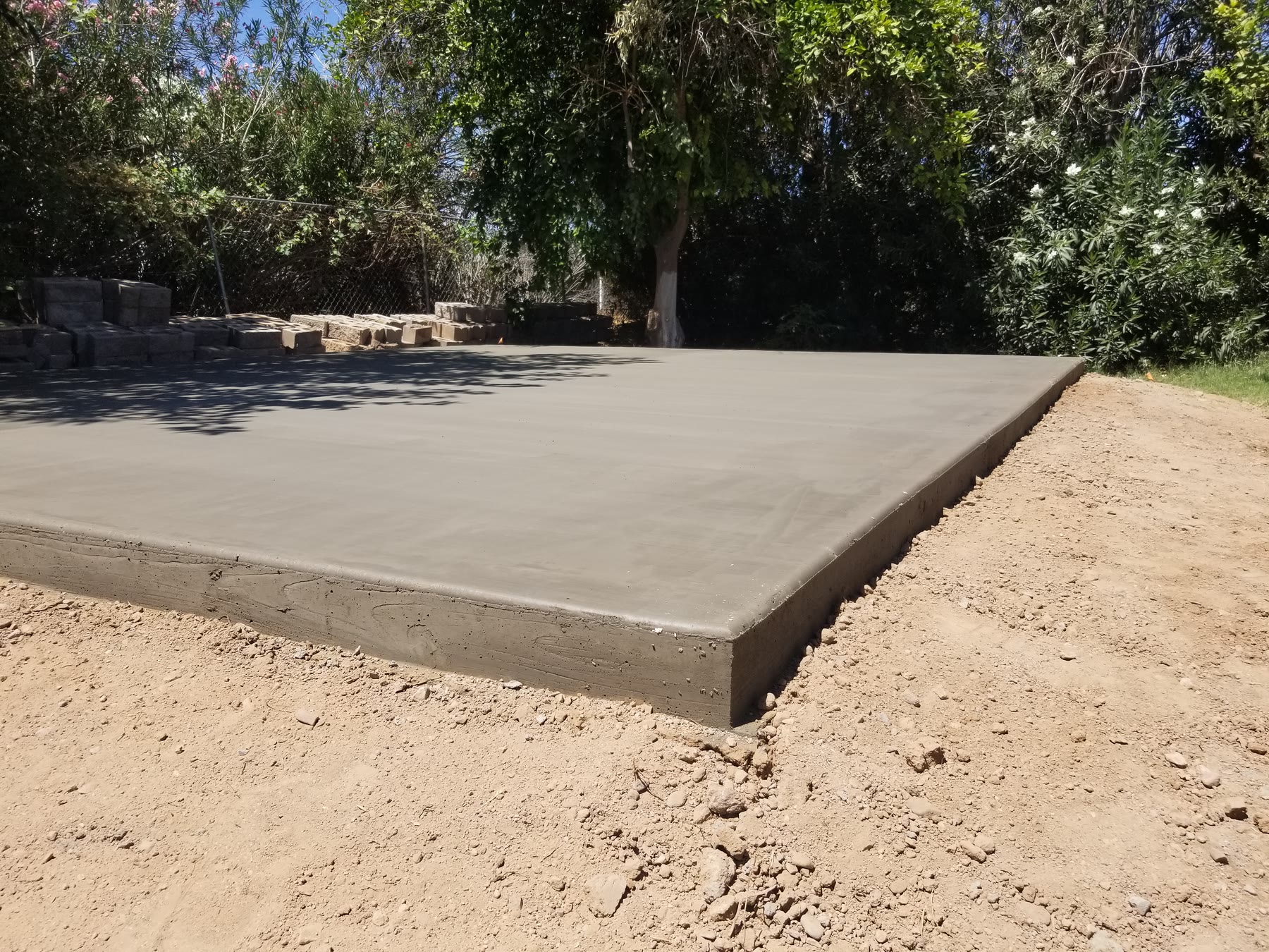 Finished edge and smooth surface of a concrete shed pad in Gilbert