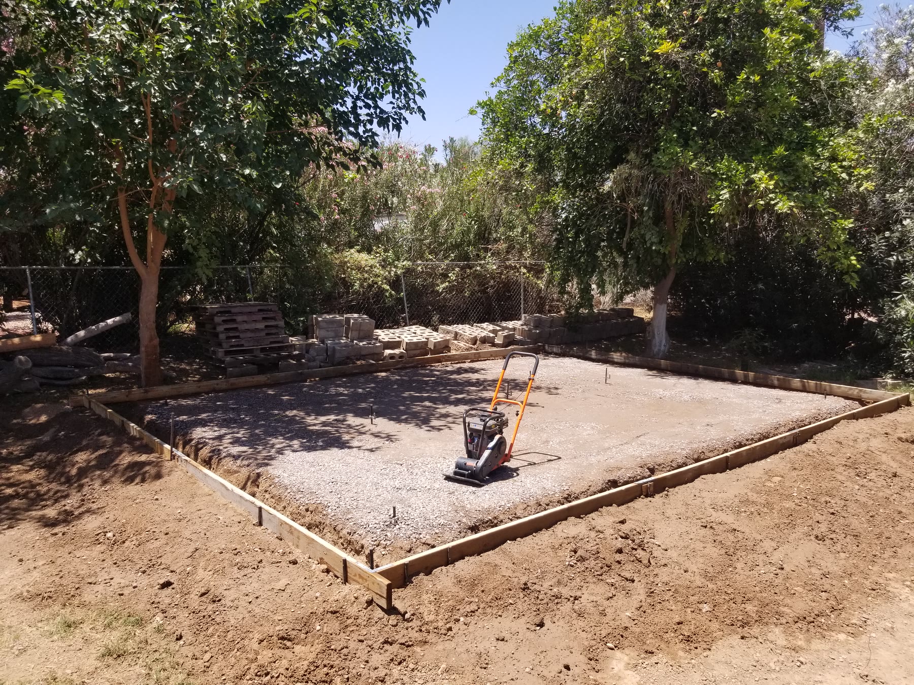 Timber forms around a compacted gravel base for a Gilbert shed pad