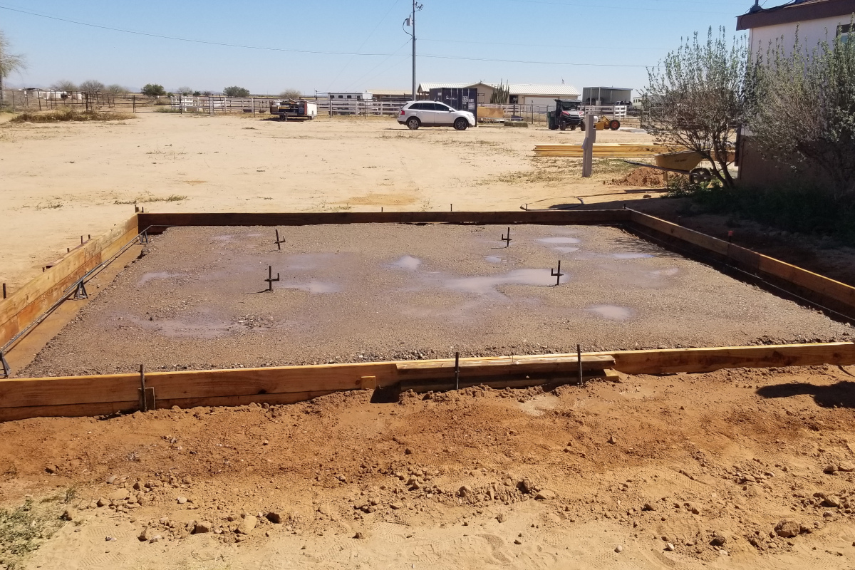 Forms, prepared base and visible edge reinforcement for a Maricopa concrete pad