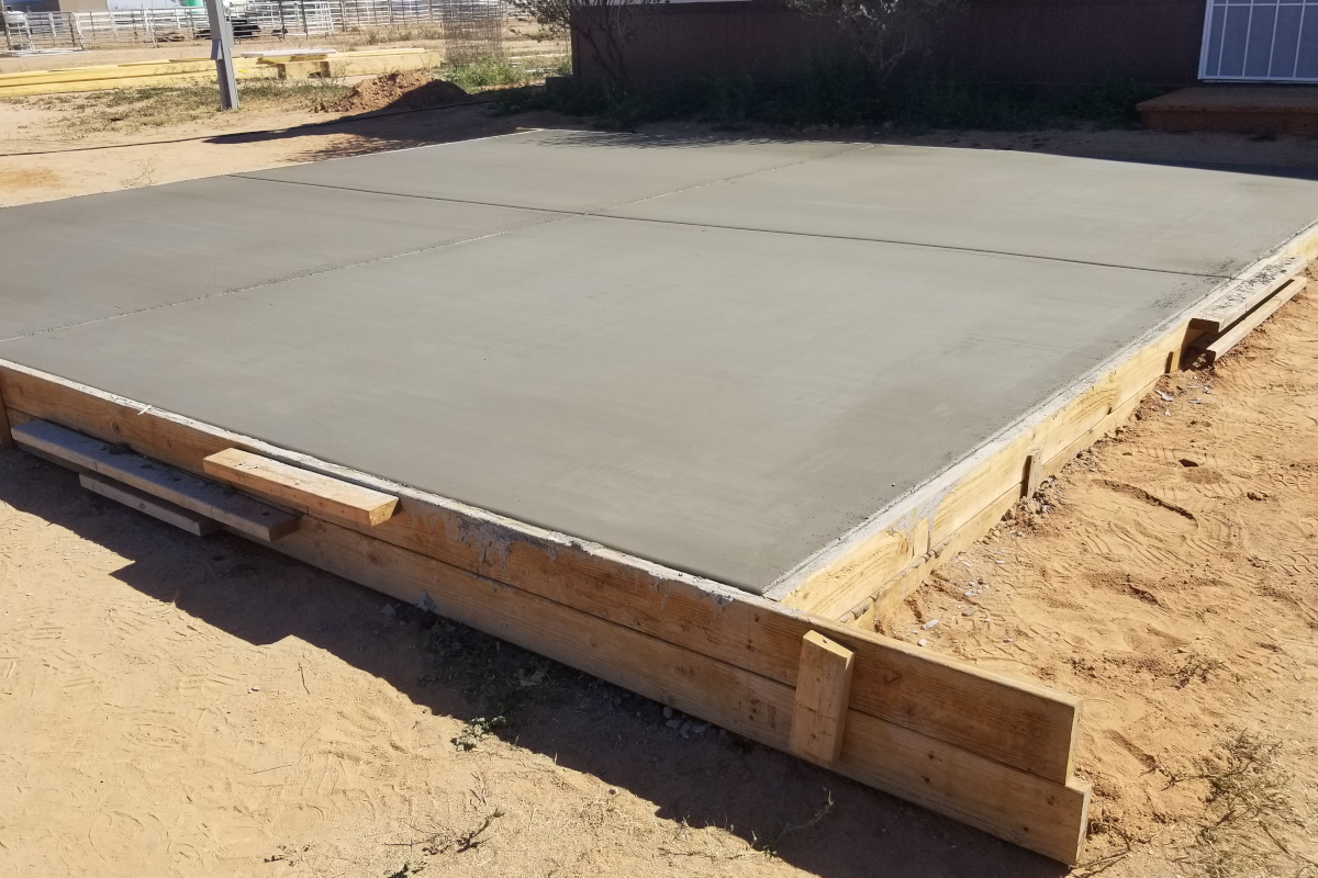 Freshly placed concrete pad inside timber forms in Maricopa