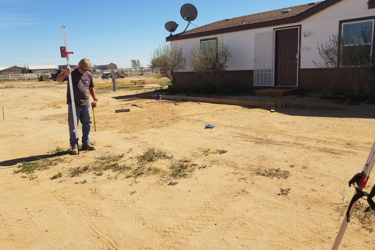 Crew laying out a concrete pad beside a Maricopa home