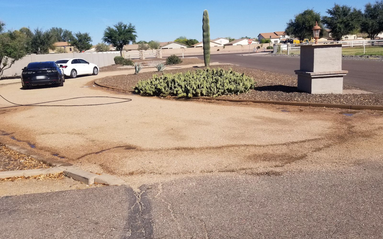 Existing curved driveway area at a San Tan Valley home before new concrete work.