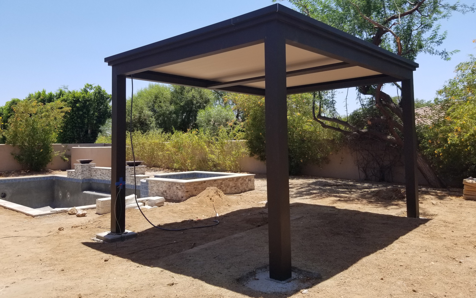 Completed motorized pergola beside a Scottsdale backyard pool.
