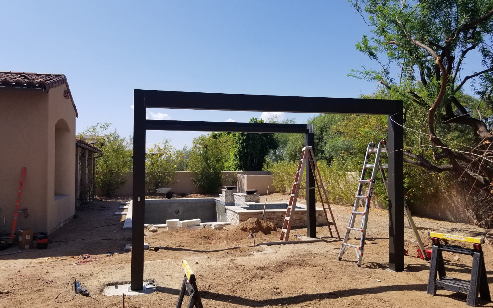 Open metal frame of a motorized pergola being assembled in Scottsdale