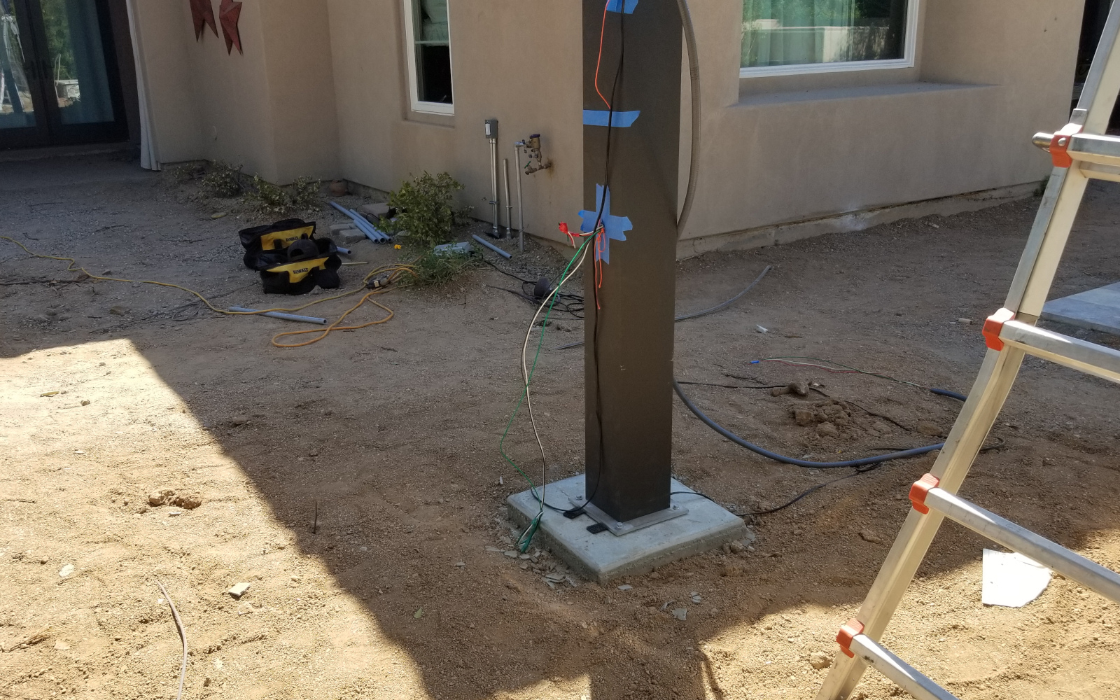 Pergola post secured to a finished concrete footing in Scottsdale