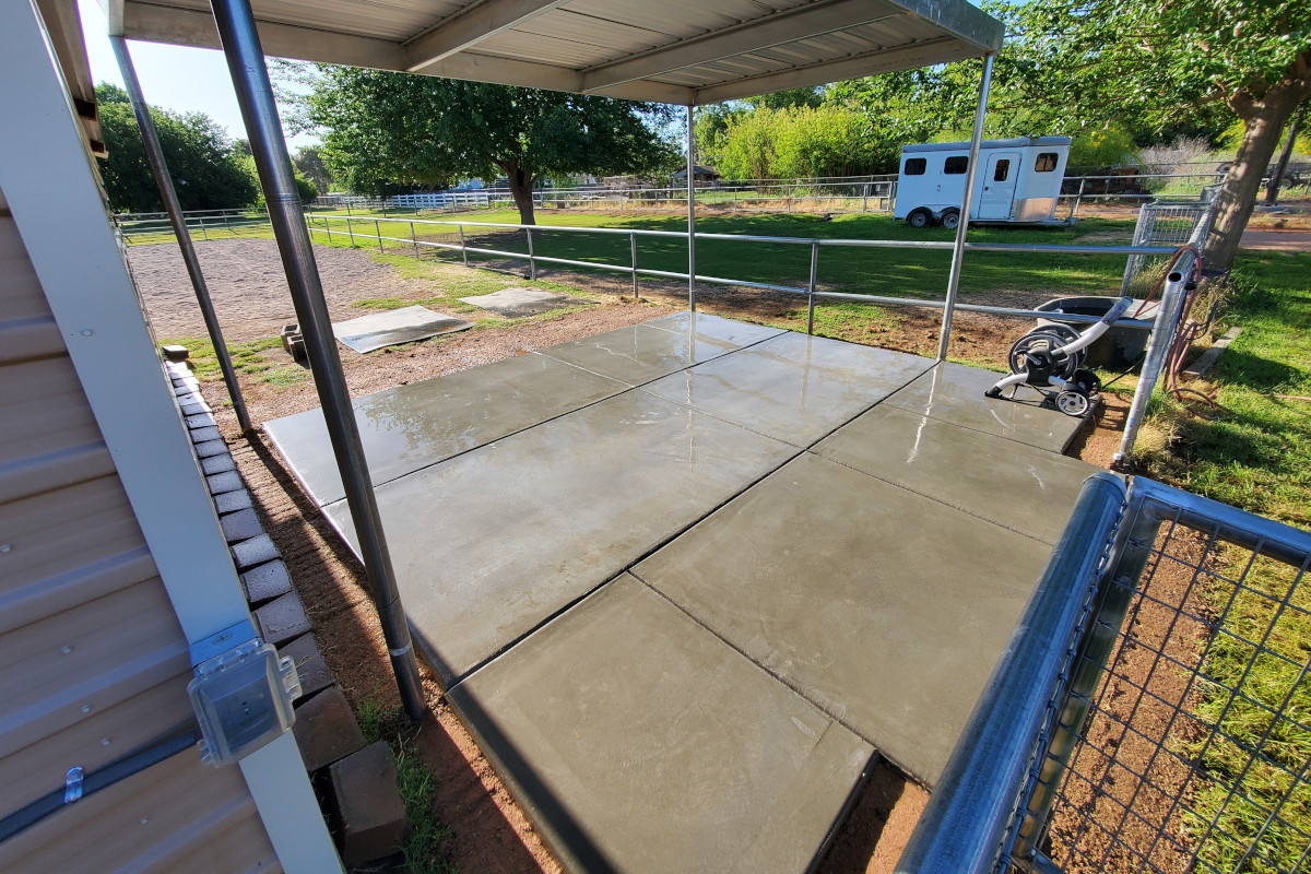 Finished concrete storage pad under a covered bay in Queen Creek, Arizona.
