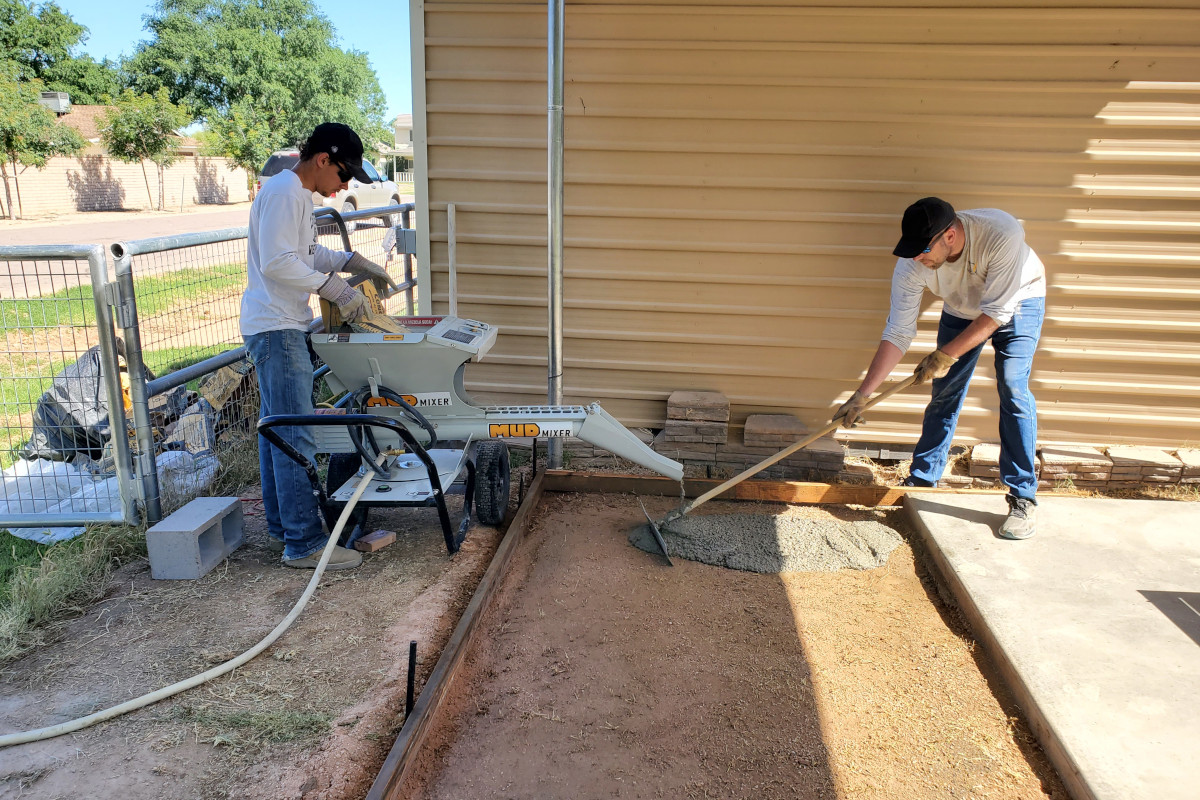 Bagged concrete being mixed and placed with a MudMixer during the Queen Creek storage pad pour.