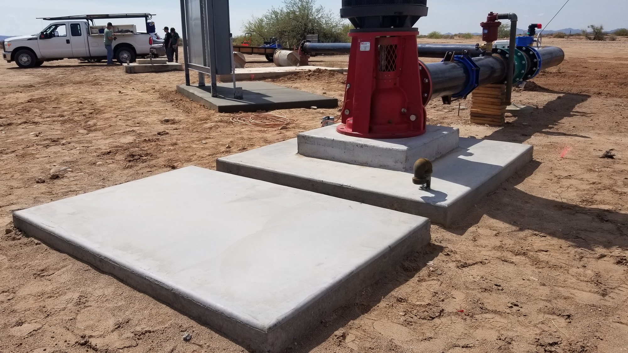 Concrete pads supporting large industrial equipment at an outdoor work site